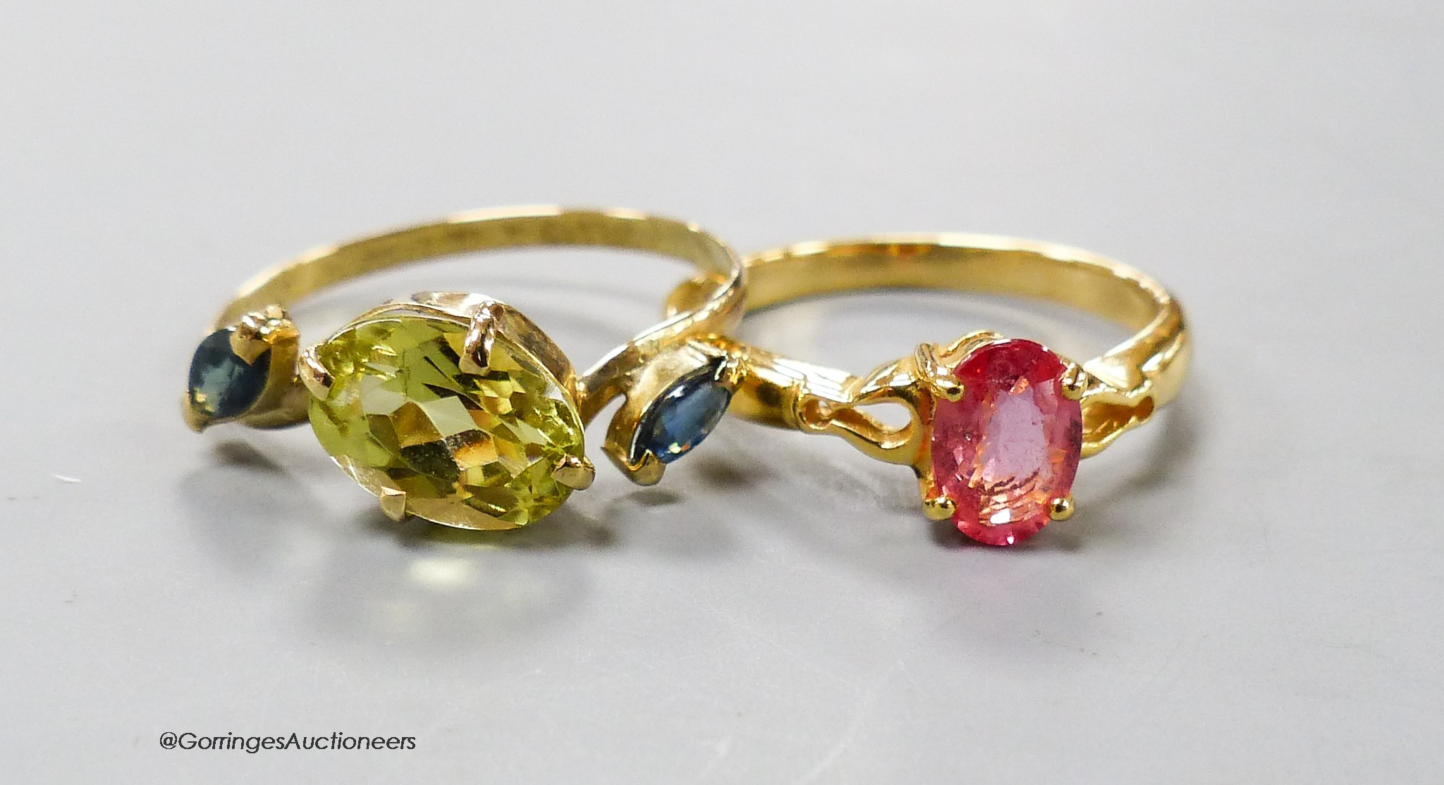 A modern 18ct gold and gem set dress ring and a similar 18k ring, gross 4.4 grams.